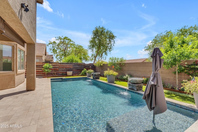 view of swimming pool featuring a fenced in pool, a fenced backyard, and a patio