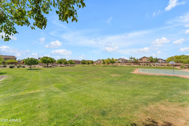 view of yard with community basketball court and a residential view