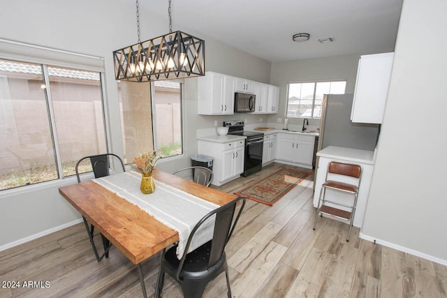 dining room featuring sink and light hardwood / wood-style flooring