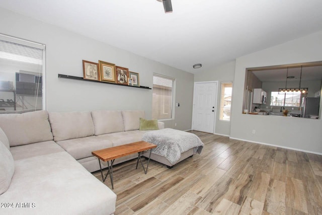 living room featuring wood-type flooring and vaulted ceiling