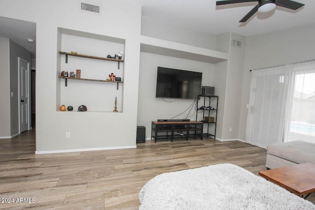 living room featuring ceiling fan and light wood-type flooring