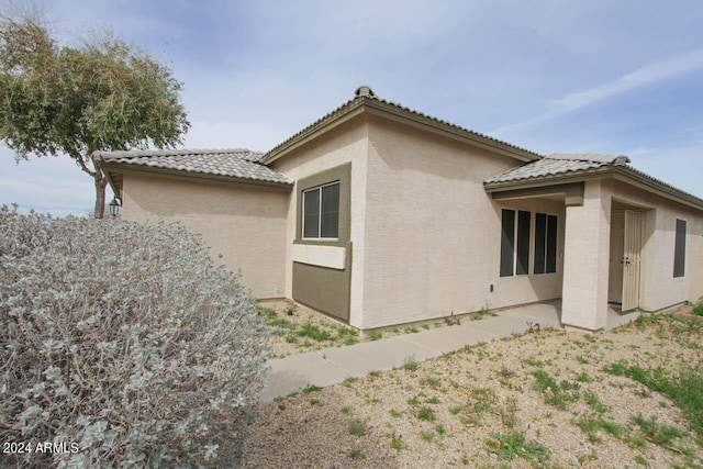 view of side of property featuring a patio area