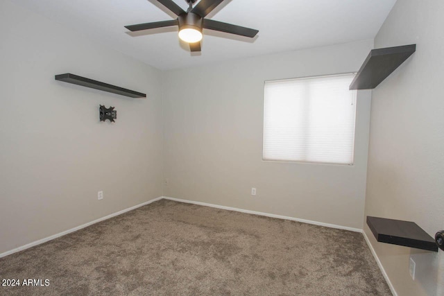 empty room with ceiling fan and carpet