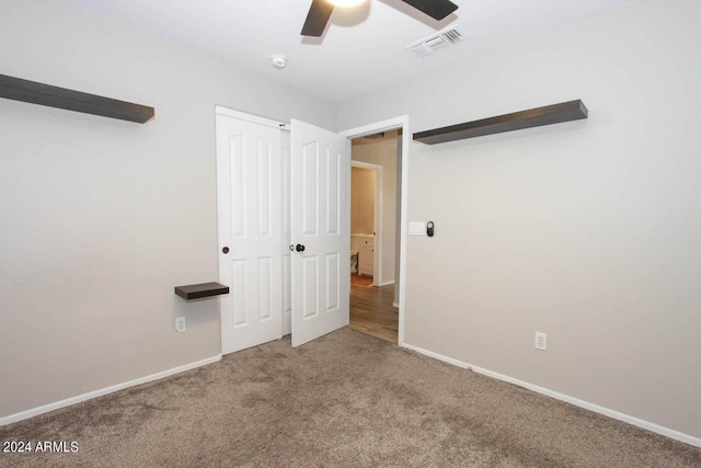 unfurnished bedroom with ceiling fan and carpet floors