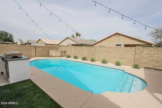 view of pool featuring a grill