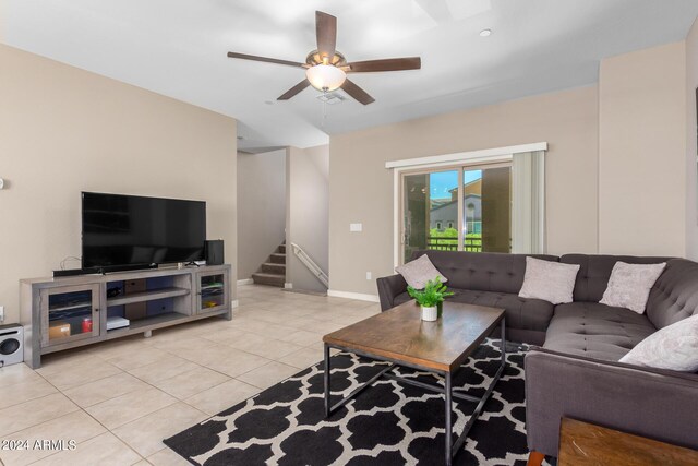 kitchen with decorative light fixtures, ceiling fan with notable chandelier, light stone countertops, appliances with stainless steel finishes, and a center island