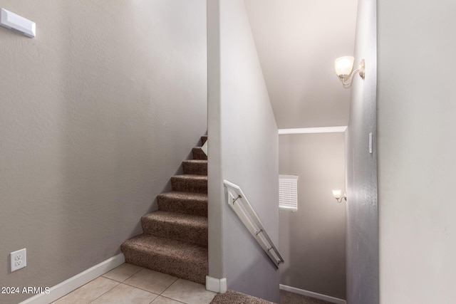 stairs with tile patterned floors