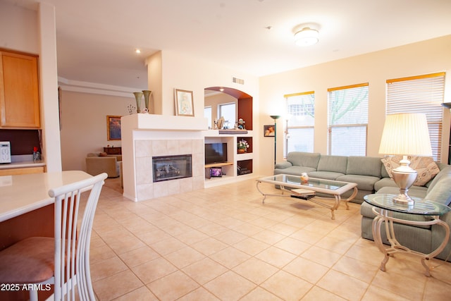 7413 E Russet Sky Dr, Scottsdale, AZ 85266 - living area with light tile patterned floors, built in shelves, and a fireplace
