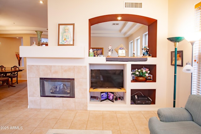7413 E Russet Sky Dr, Scottsdale, AZ 85266 - tiled living area featuring a tile fireplace, built in features, arched walkways, and baseboards