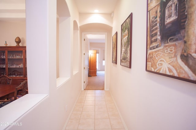 7413 E Russet Sky Dr, Scottsdale, AZ 85266 - hallway with light tile patterned flooring, arched walkways, baseboards, and recessed lighting