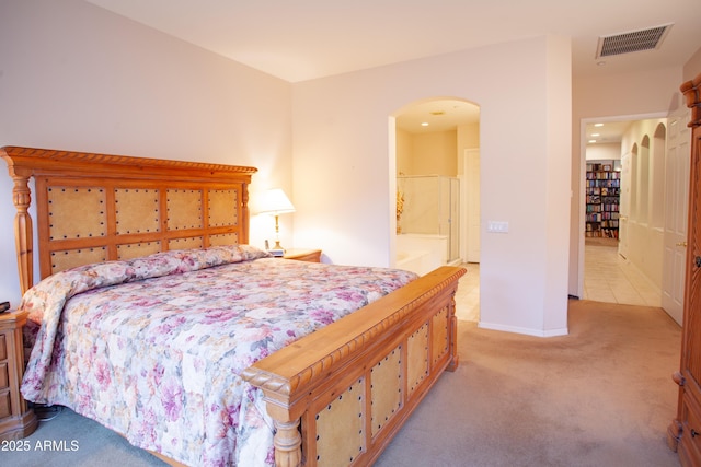 7413 E Russet Sky Dr, Scottsdale, AZ 85266 - bedroom featuring arched walkways, light carpet, baseboards, and ensuite bath