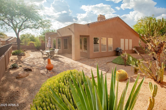 7413 E Russet Sky Dr, Scottsdale, AZ 85266 - back of house with a chimney, a fenced backyard, a patio, stucco siding, and a tiled roof