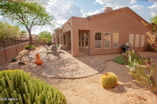 7413 E Russet Sky Dr, Scottsdale, AZ 85266 - back of house featuring a fenced backyard, stucco siding, a patio, a tile roof, and a chimney