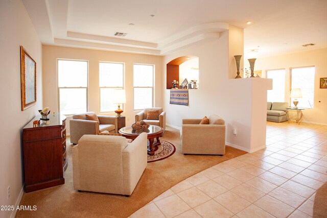 7413 E Russet Sky Dr, Scottsdale, AZ 85266 - living room featuring healthy amount of natural light, tile patterned floors, arched walkways, and baseboards