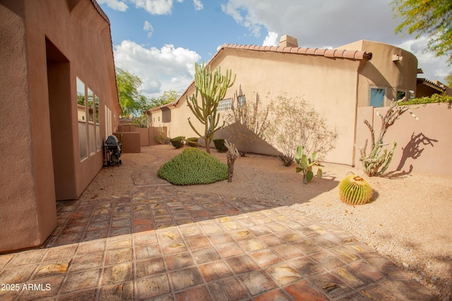 7413 E Russet Sky Dr, Scottsdale, AZ 85266 - view of property exterior with stucco siding, a patio area, a fenced backyard, a tiled roof, and a chimney