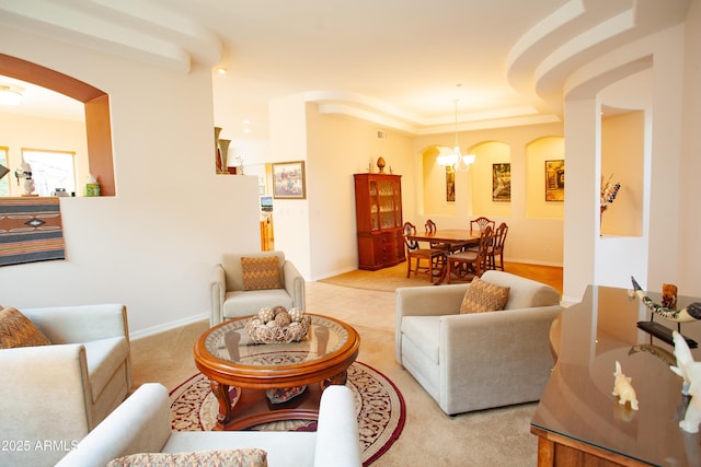 7413 E Russet Sky Dr, Scottsdale, AZ 85266 - living area featuring arched walkways, baseboards, and a tray ceiling