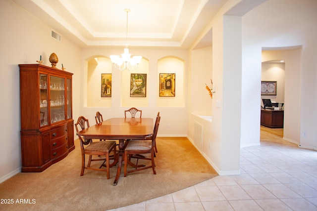 7413 E Russet Sky Dr, Scottsdale, AZ 85266 - dining area featuring a chandelier, light carpet, a raised ceiling, and light tile patterned floors