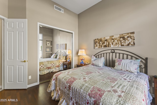 bedroom featuring dark wood-type flooring and a closet