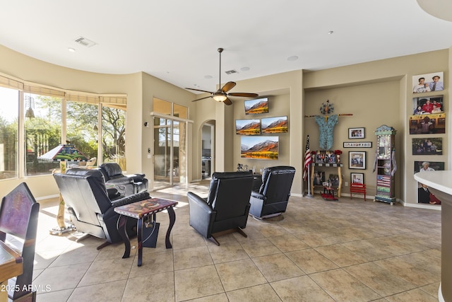 tiled living room with ceiling fan