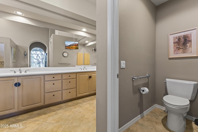 bathroom featuring vanity, toilet, and tile patterned flooring