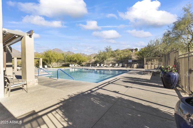 view of swimming pool with a patio and a mountain view