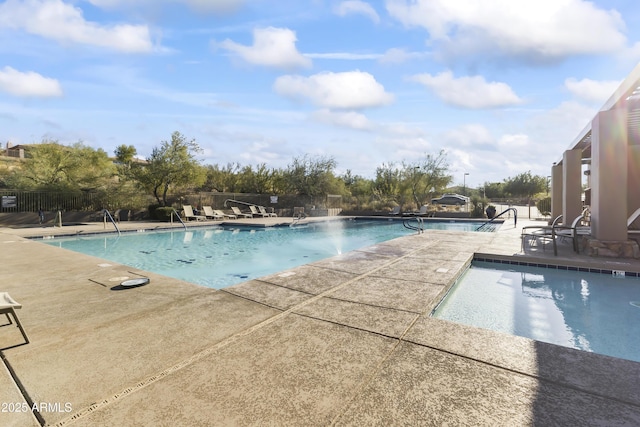 view of swimming pool with a patio area