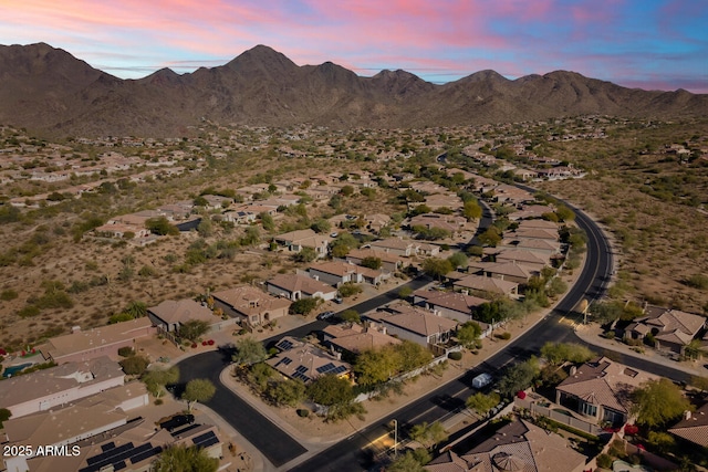 aerial view at dusk featuring a mountain view