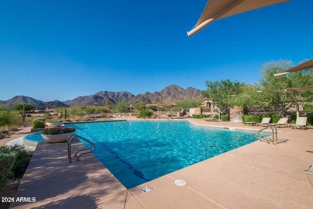 view of pool with a mountain view and a patio area