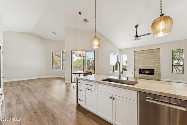 11008 N 119th Pl, Scottsdale, AZ 85259 - kitchen featuring stainless steel dishwasher, open floor plan, lofted ceiling, a fireplace, and healthy amount of natural light