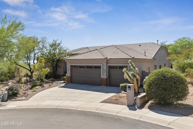 11008 N 119th Pl, Scottsdale, AZ 85259 - view of front of house with an attached garage, driveway, a tiled roof, and stucco siding