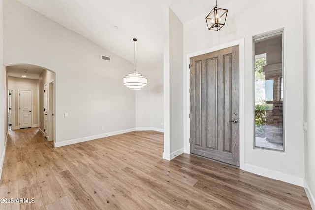 11008 N 119th Pl, Scottsdale, AZ 85259 - entrance foyer with arched walkways, light wood finished floors, high vaulted ceiling, and a chandelier