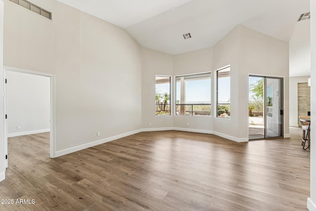 11008 N 119th Pl, Scottsdale, AZ 85259 - spare room with high vaulted ceiling, healthy amount of natural light, and wood finished floors