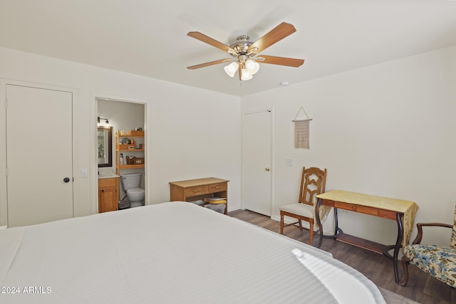 bedroom with ensuite bath, ceiling fan, and dark hardwood / wood-style flooring