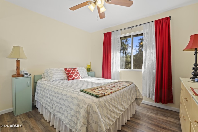 bedroom with ceiling fan and dark wood-type flooring