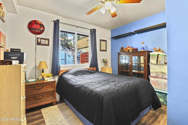 bedroom with ceiling fan and dark hardwood / wood-style flooring