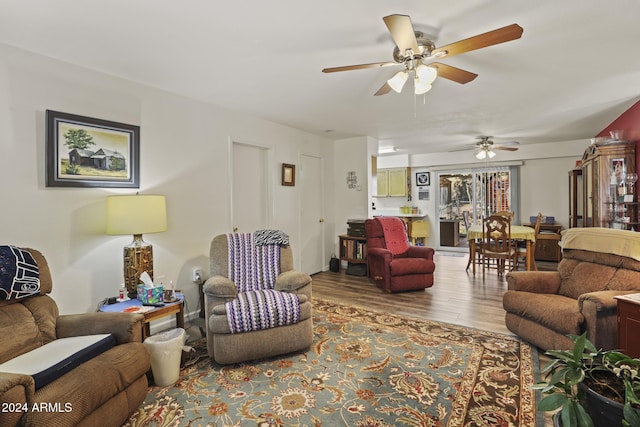 living room featuring light hardwood / wood-style floors and ceiling fan