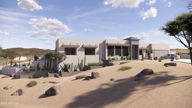 adobe home featuring stucco siding, a mountain view, and a garage