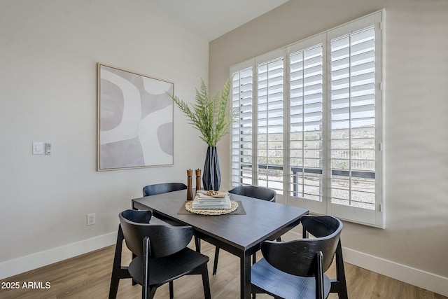 dining area with plenty of natural light and light wood-type flooring