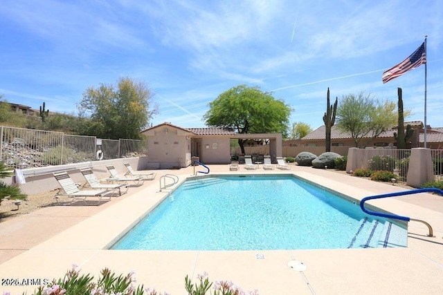 view of swimming pool with a patio area