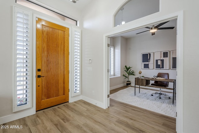 entrance foyer with ceiling fan and light hardwood / wood-style flooring