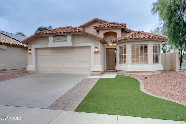 2203 E Crest Ln, Phoenix, AZ 85024 - mediterranean / spanish-style home with an attached garage, driveway, stucco siding, and a tiled roof