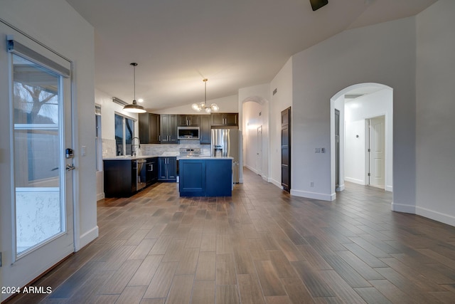 2203 E Crest Ln, Phoenix, AZ 85024 - kitchen with appliances with stainless steel finishes, arched walkways, lofted ceiling, light countertops, and tasteful backsplash