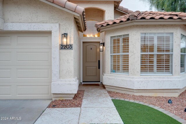 2203 E Crest Ln, Phoenix, AZ 85024 - doorway to property with stucco siding, a garage, and a tile roof