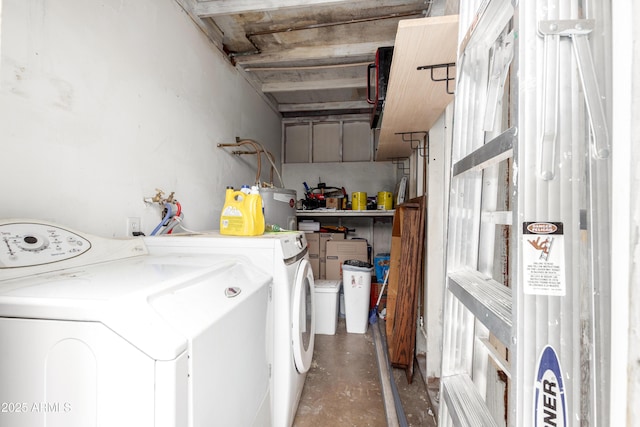 clothes washing area with laundry area, independent washer and dryer, and water heater