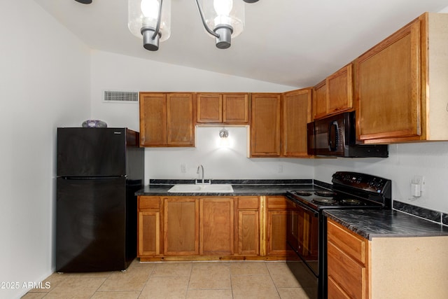 kitchen featuring a sink, brown cabinetry, lofted ceiling, black appliances, and visible vents