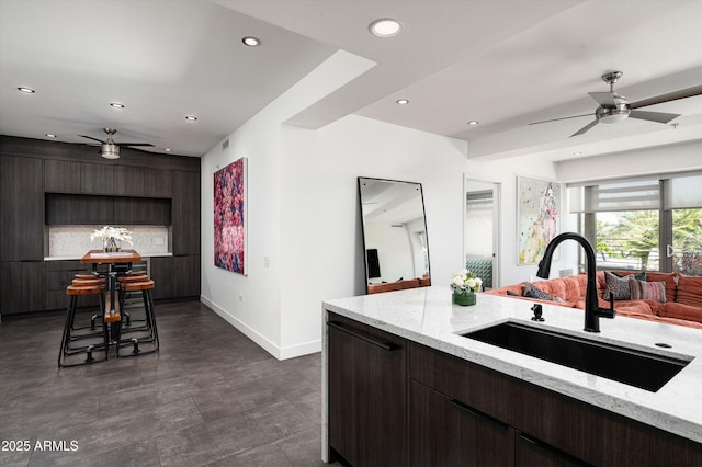 kitchen with a ceiling fan, baseboards, recessed lighting, and a sink