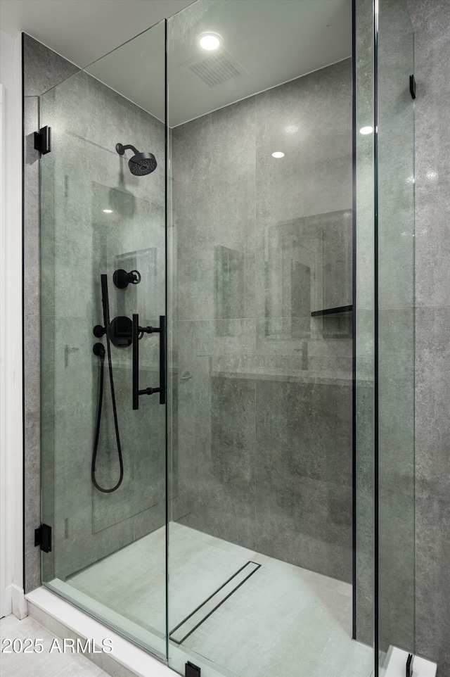 bathroom featuring a shower stall and visible vents