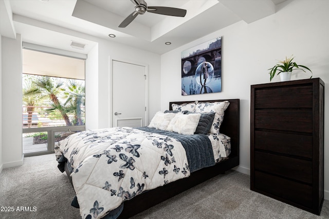 carpeted bedroom with baseboards, a raised ceiling, visible vents, and multiple windows