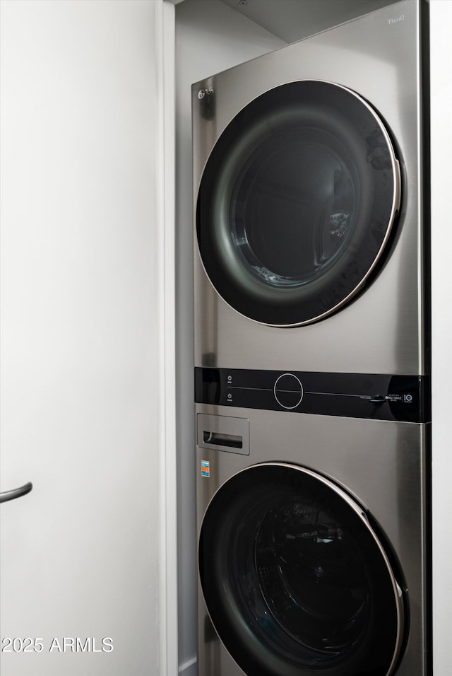 washroom featuring laundry area and stacked washer / dryer