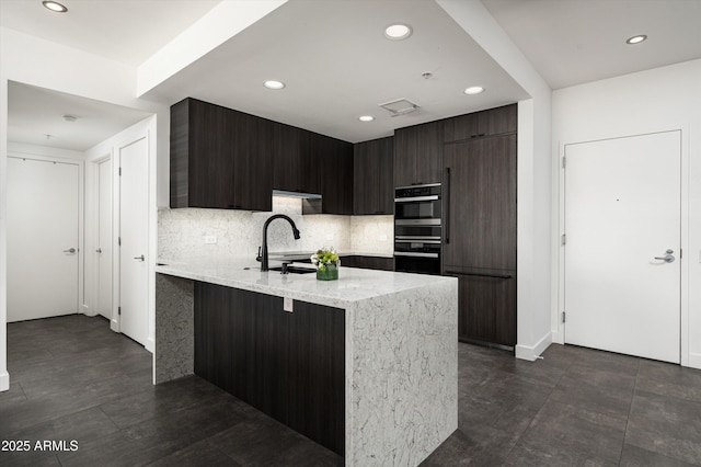 kitchen with recessed lighting, modern cabinets, and tasteful backsplash